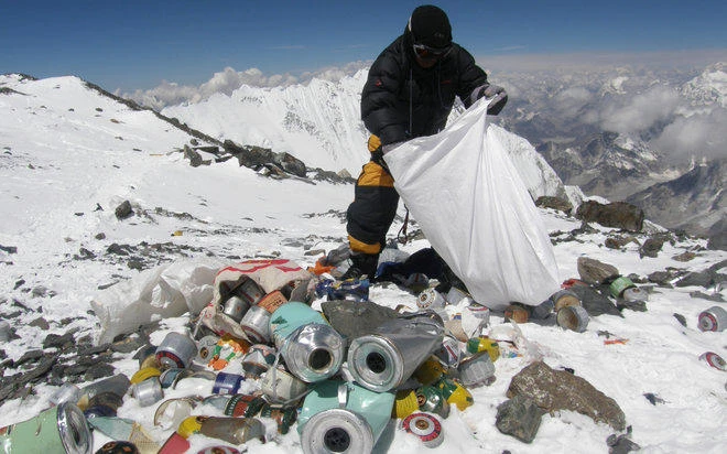 A Sherpa bags litter on Mount Everest at 8,000 meters. (AFP)