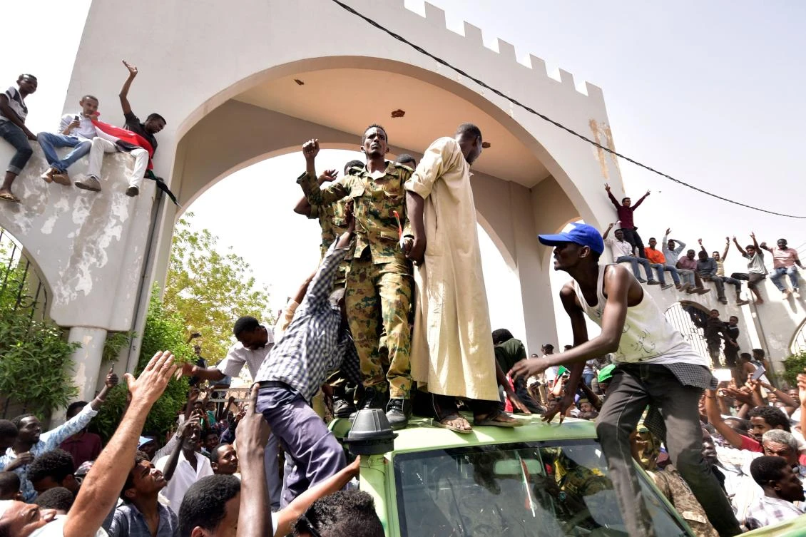 Sudanese demonstrators gather in a street in central Khartoum on April 11, 2019, after one of Africa's longest-serving presidents was toppled by the army. (AFP)