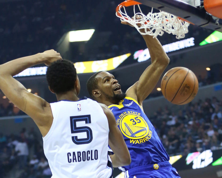 Golden State Warriors forward Kevin Durant dunks the ball as Memphis Grizzlies forward Bruno Caboclo defends in the second quarter at FedExForum in Memphis, Tennessee. (Nelson Chenault-USA TODAY Sports)