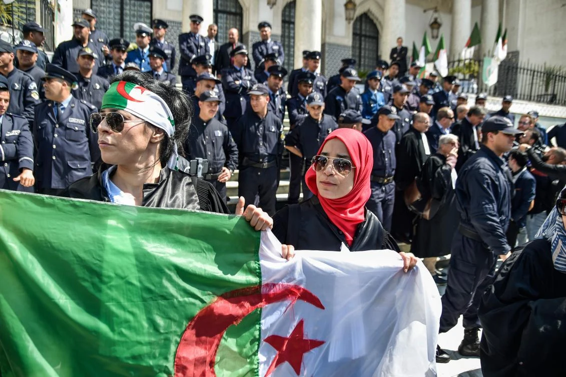 Algerian women wave a national flag during a demonstration for the independence of the judiciary outside the Justice Ministry headquarters in the capital Algiers on April 13, 2019. (AFP)