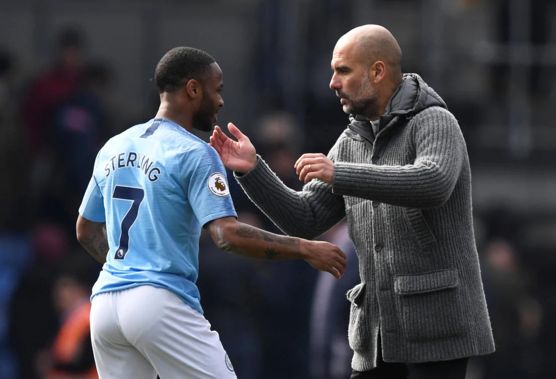 Manchester City's Raheem Sterling celebrates after the match with manager Pep Guardiola. (Action Images via Reuters)