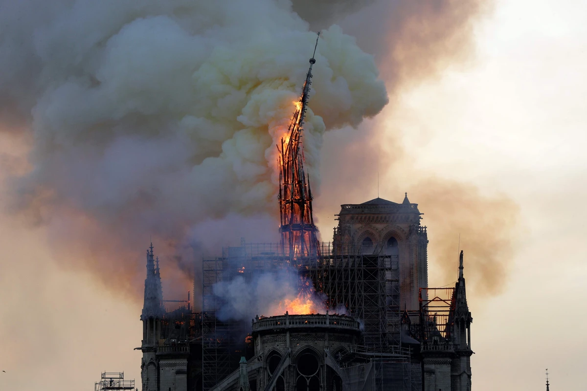 The soaring spire collapsed in flames, and a church spokesman says the entire wooden interior of the 12th century landmark is burning and likely to be destroyed. (AFP)