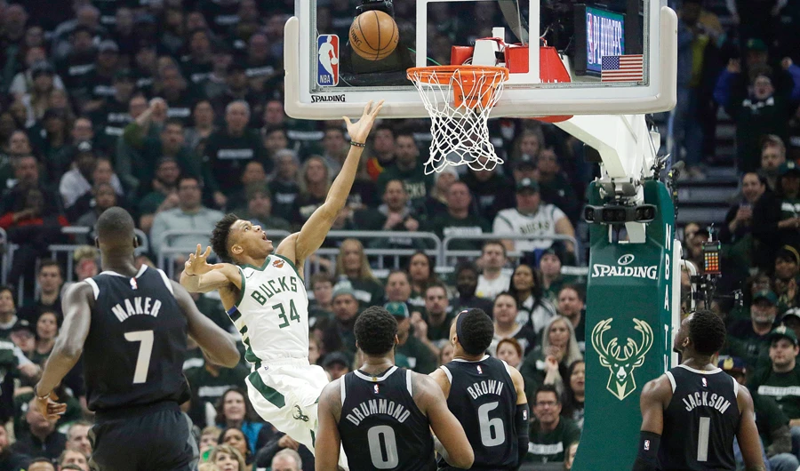 Milwaukee Bucks' Giannis Antetokounmpo shoots against multiple Detroit Pistons defenders during their game Sunday. (AP)