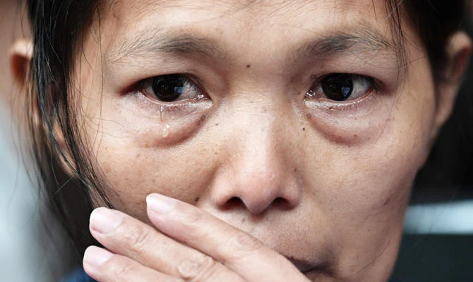Baby Jane Allas, a 38-year-old mother of five Filipina domestic worker who was sacked after she was diagnosed with cervical cancer, reacts after a hearing at the Labour Tribunal in Hong Kong on April 15, 2019, which ordered her former employer to pay a settlement of 30,000 HKD in damages. (AFP)