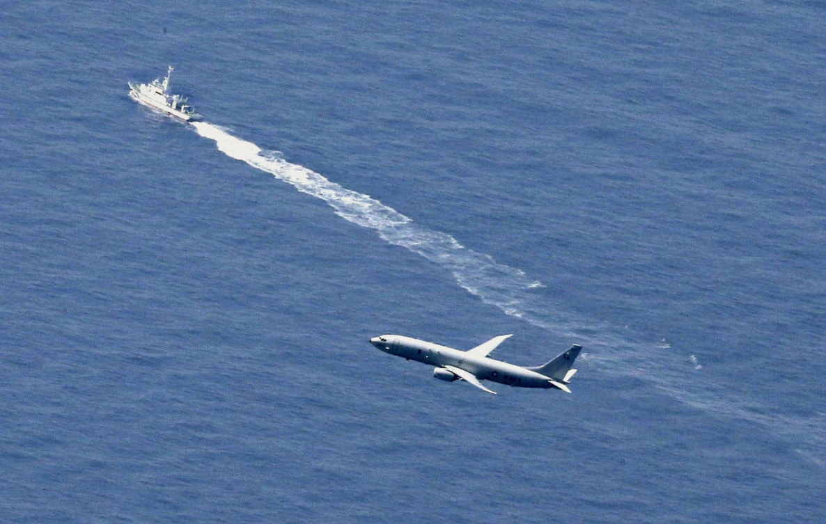 A Japanese Coast Guard vessel and US military plane search for a Japanese F-35A stealth fighter jet in the waters off Aomori, northern Japan on April 10, 2019. (Kyodo News via AP)