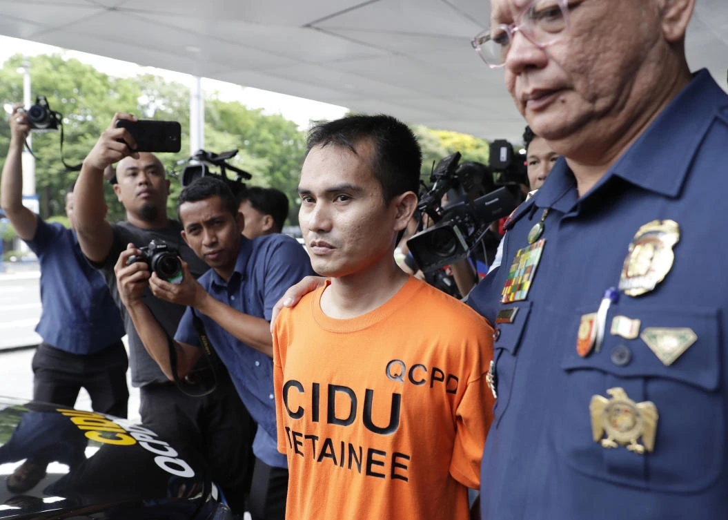 Suspected Abu Sayyaf Group (ASG) member Abuhair Kullim Indal, center, is escorted to a police car after being presented to reporters at Camp Crame police headquarters in metropolitan Manila, Philippines, Monday, April 15, 2019. (AP)
