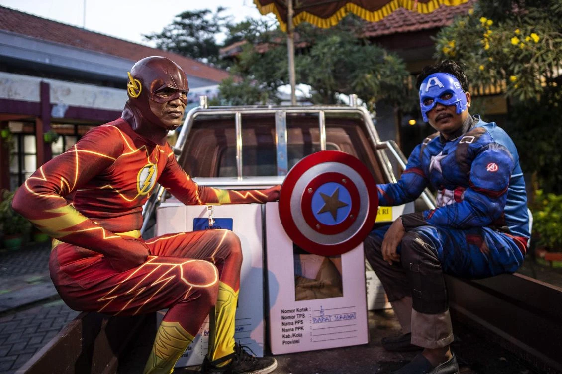 Indonesian election commission workers wearing superhero costumes deliver ballot boxes for the upcoming general elections in Surabaya, East Java on April 16, 2019. (AFP)