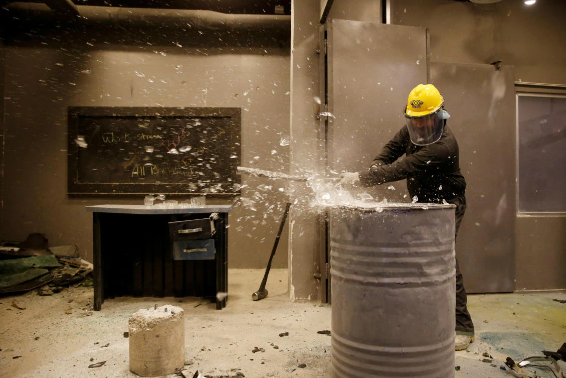 A participant smashes items at Axe Rage Room, where people can express their anger in an entertaining way in Amman, Jordan. (Reuters)