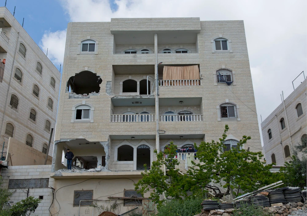 Holes are seen in the two apartments belonging to the father of Arafat Erfayieh, that was bulldozed Israeli forces in the West Bank city of Hebron, Friday, April 19, 2019. (AP)