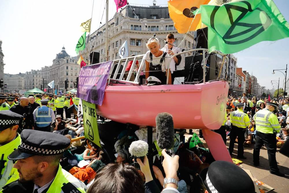 British actress Emma Thompson gives an address from the stage atop the pink boat to climate change activists occupying the road junction at Oxford Circus in central London on April 19, 2019 during the fifth day of an environmental protest by the Extinction Rebellion group. (AFP)