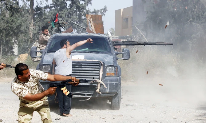 Libyan fighters loyal to the Government of National Accord (GNA) fire their guns during clashes with forces loyal to strongman Khalifa Haftar south of the capital Tripoli's suburb of Ain Zara, on April 20, 2019. (AFP)
