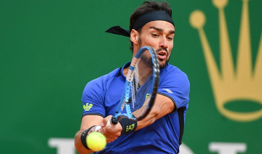Italy's Fabio Fognini returns a ball to Spain's Rafael Nadal during the semi final tennis match of the Monte-Carlo ATP Masters Series tournament in Monaco on April 20, 2019. (AFP / YANN COATSALIOU)