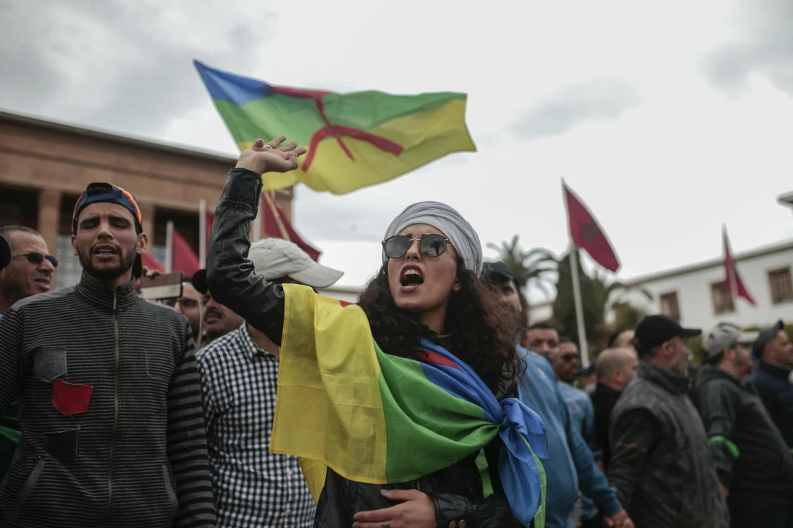 Moroccans wave Berber flags and chant slogans as they take part in a demonstration in Rabat, Morocco, Sunday, April 21, 2019. Protesters are condemning prison terms for the leader of the Hirak Rif protest movement against poverty and dozens of other activists. (AP)