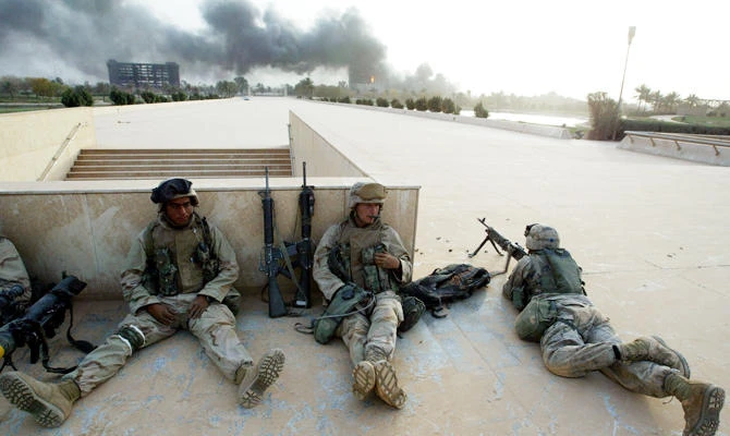 U.S. Marines from Lima Company, a part of a 7-th Marine Regiment take a rest in front of the Martyrs Monument (not pictured) in Baghdad April 9, 2003. (REUTERS)