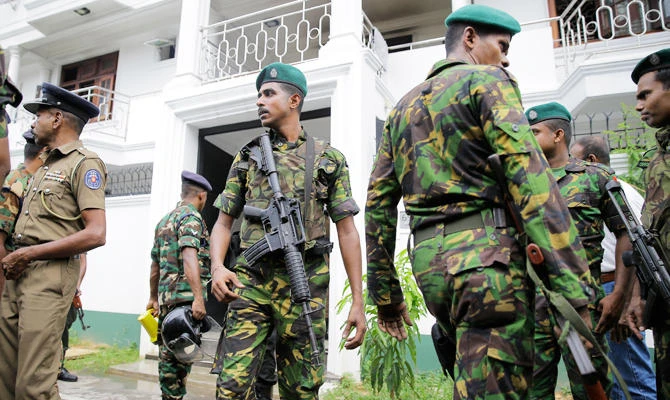 Sri Lankan security forces officers secure a site believed to be a hide out of the militants following a shoot out in Colombo, Sri Lanka, Sunday, April 21, 2019. (AP)