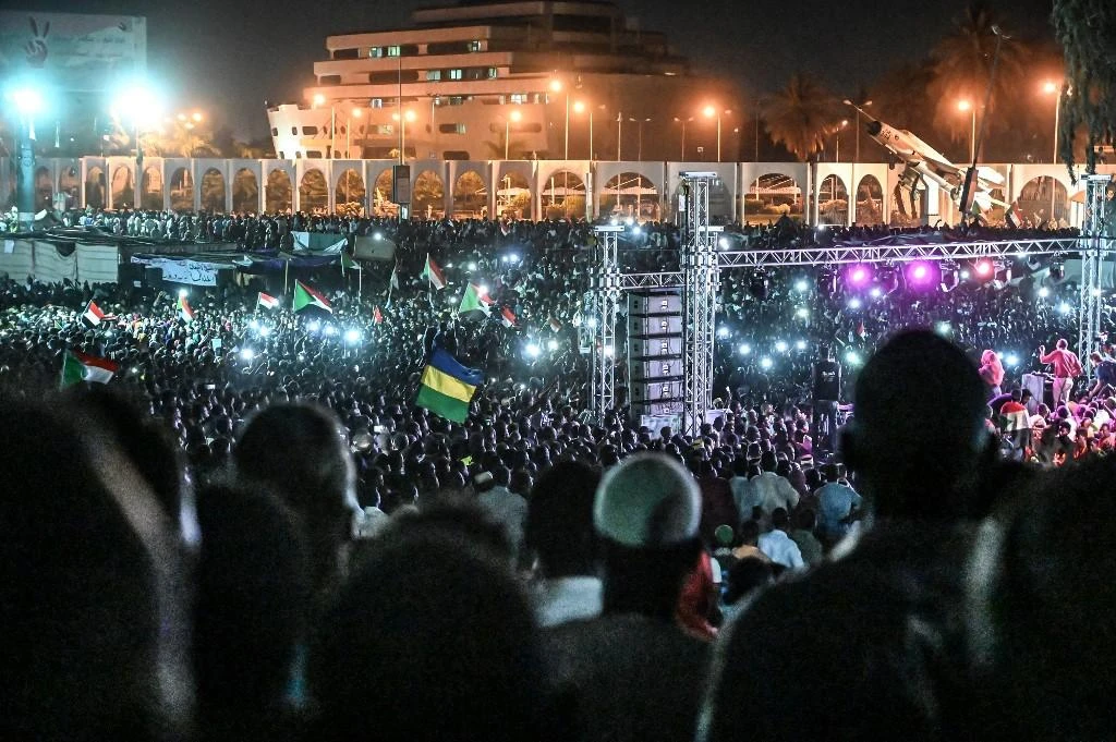 Demonstrators lit the night sky with cellphones while chanting protest slogans and songs. (AFP)