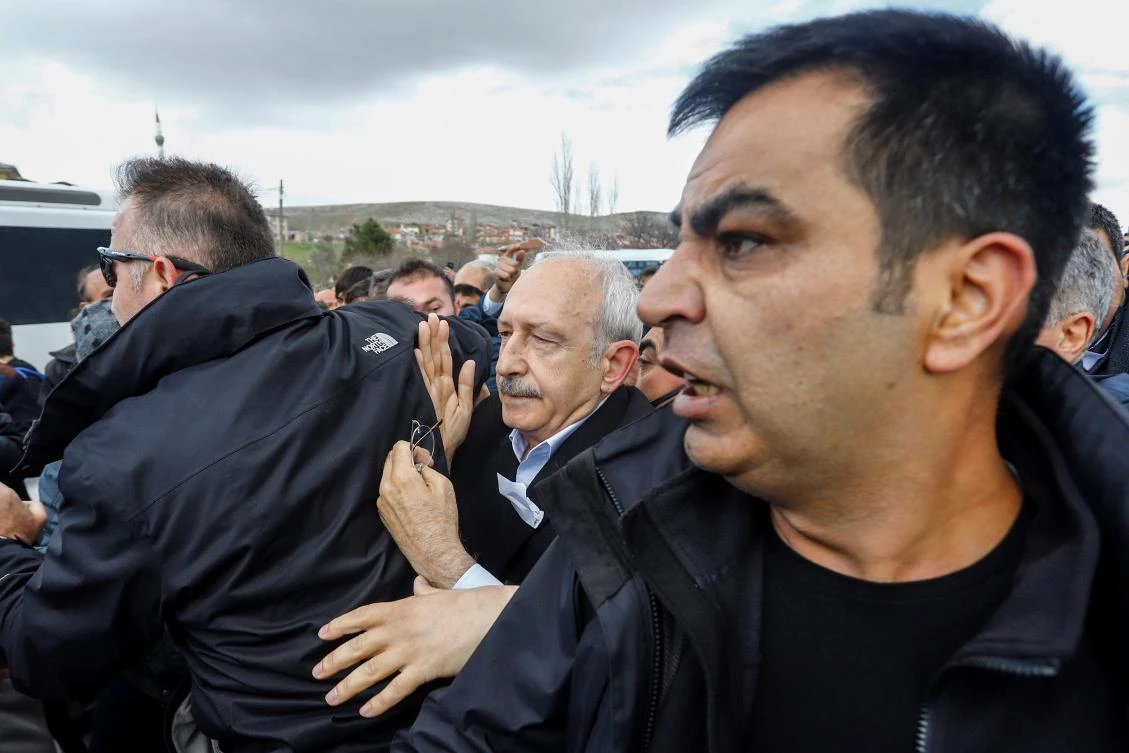 Kemal Kilicdaroglu, center, chairman of the Republican People’s Party, is protected by bodyguards after he was attacked by protesters on April 21, 2019. (Demiroren News Agency/AFP)