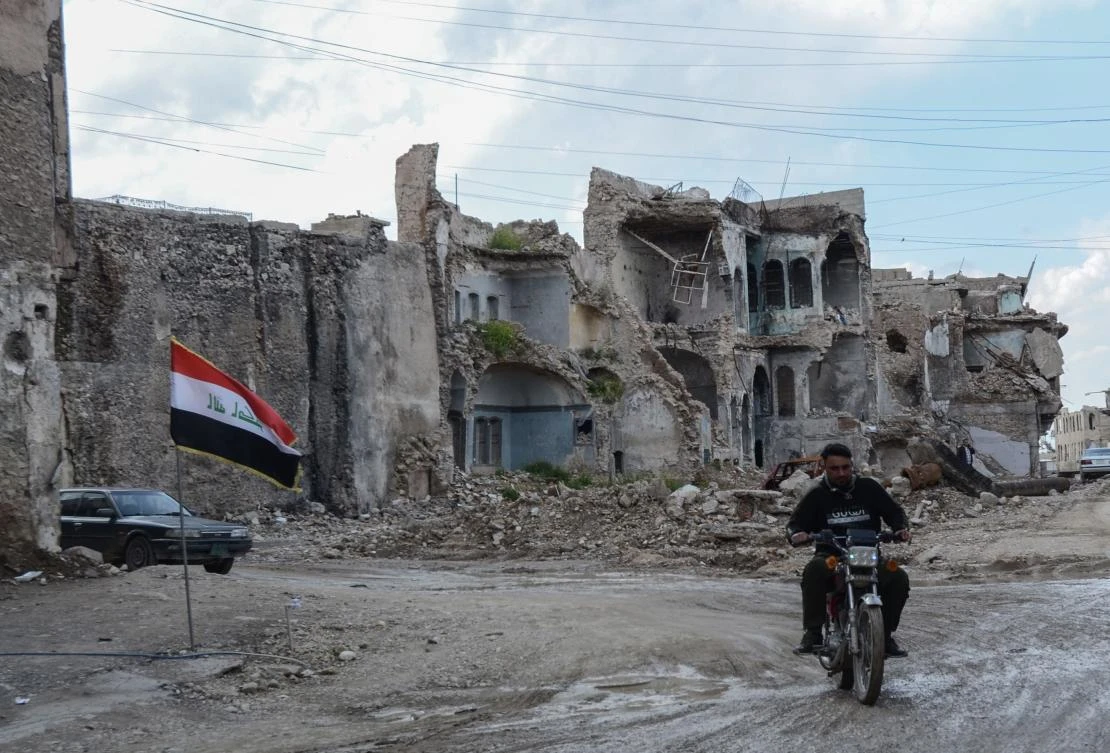 A man rides a motorcycle among devastated buildings in the old city of Mosul, in northern Iraq on April 21, 2019. (AFP)