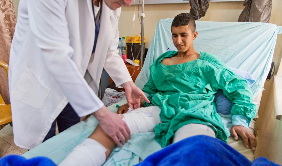 Osama Hajjahjeh, 16, said he was trying to run from soldiers when he was shot. (AP)