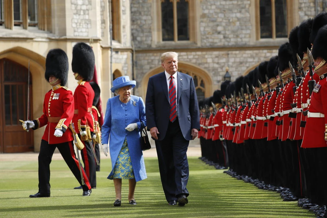 In this Friday, July 13, 2018 file photo, U.S. President Donald Trump and Britain's Queen Elizabeth inspects the Guard of Honour at Windsor Castle in Windsor, England. U.S. President Donald Trump will pay a state visit to Britain in June as a guest of Queen Elizabeth II, Buckingham Palace said Tuesday, April 23, 2019. (AP)