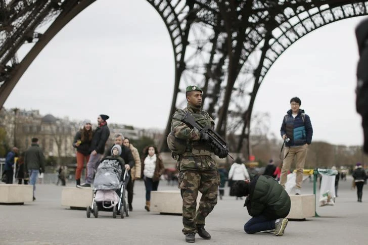 A French soldier patrols near the Eiffel Tower as part of the highest level of "Vigipirate" security plan after a shooting at the Paris offices of Charlie Hebdo January 12, 2015. (Reuters)