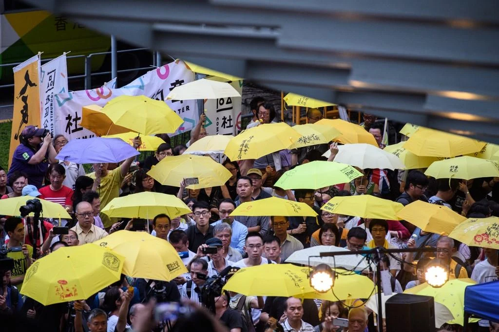 Hong Kong activists open yellow umbrellas during a gathering to mark the fourth anniversary of mass pro-democracy rallies, known as the Umbrella Movement, on September 28, 2018. (AFP)