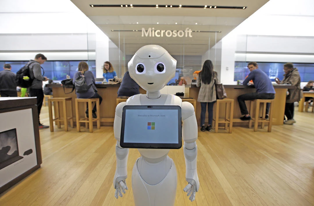 In this March 21, 2019, file photo a robot called "Pepper" is positioned near an entrance to a Microsoft Store location, in Boston. Microsoft Corp. reports earnings on April 24. (AP Photo/Steven Senne, File)