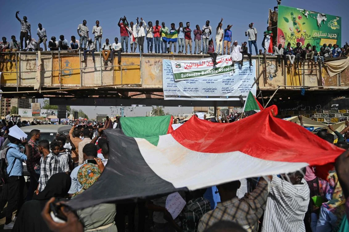 Sudanese protesters wave the national flag during a "million-strong" march outside the army headquarters in the capital Khartoum on Thursday. (AFP)