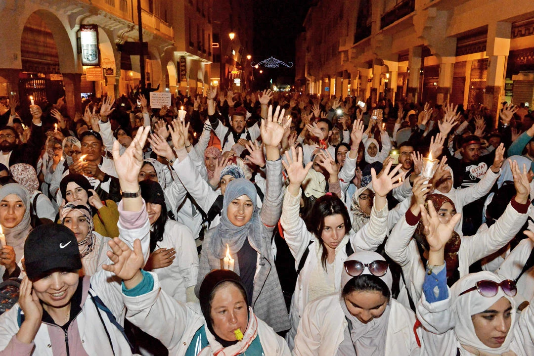 Moroccan teachers gesture during a demonstration calling for permanent contracts within the national education system, outside parliament headquarters in the capital Rabat on April 25, 2019. (AFP)