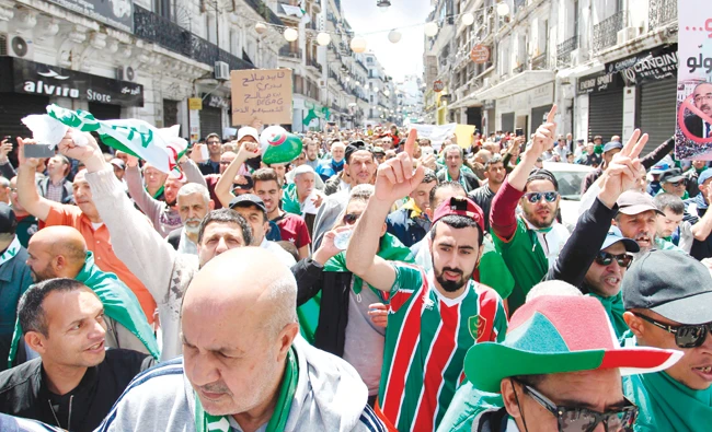 Algerians gather during an anti-government demonstration in Algiers demanding the removal of the elite and prosecution of the corrupt on Friday. (AFP)