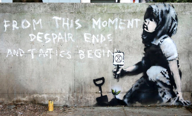 Graffiti artwork, suspected to have been created by the British street artist Banksy, is pictured opposite the environmental protest group Extinction Rebellion's camp at Marble Arch in London on April 26, 2019. (AFP)