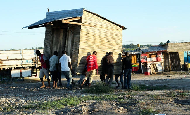 Men carry a mobile shop to safer ground in Pemba city on the northeastern coast of Mozambique, Saturday, April, 27, 2019. (AP)