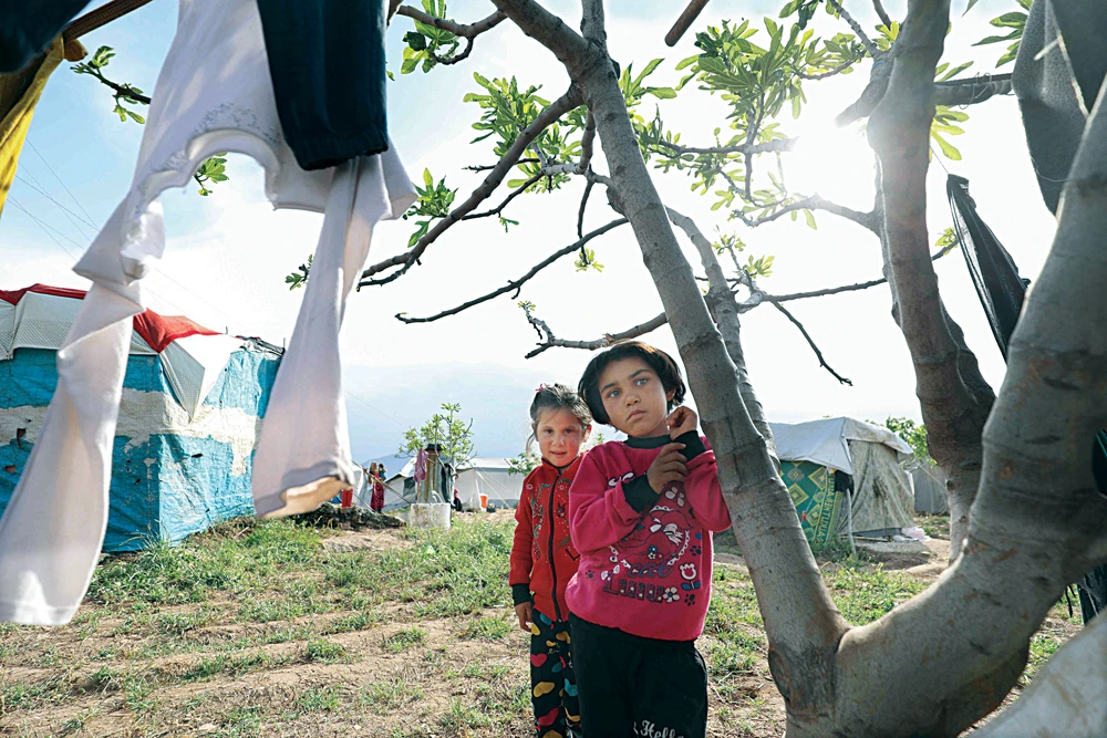 Syrian children in a makeshift camp in Sher Maghar in western-central Syria’s Hama province on Saturday. (AFP)