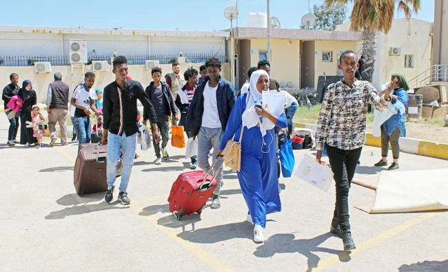 Migrants carry their luggage at Misrata airport, before their deportation and resettlement in Italy, in Misrata, Libya April 29, 2019. (REUTERS)