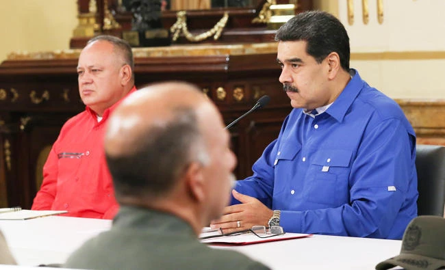 Handout photo released by the Venezuelan Presidency of Venezuela's President Nicolas Maduro (R) delivering a message at the Miraflores presidential palace next to the president of the Venezuelan National Constituent Assembly Diosdado Cabello in Caracas, on April 30, 2019. (AFP)