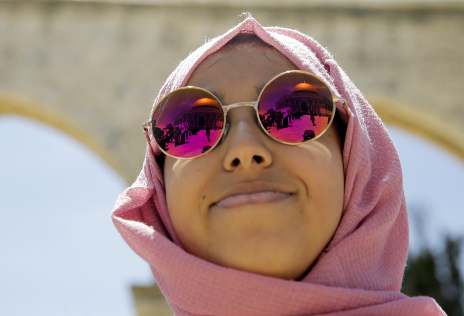 The Dome of the Rock shrine reflects in the sunglasses of a worshipper during the holy month of Ramadan in Jerusalem, Friday, May 10, 2019. (AP)