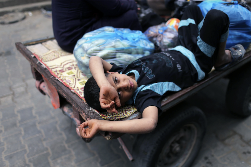 A Palestinian boy looks on as he rests on a cart, on the first day of the Muslim holy month of Ramadan, in the southern Gaza Strip May 6, 2019. (Reuters)z