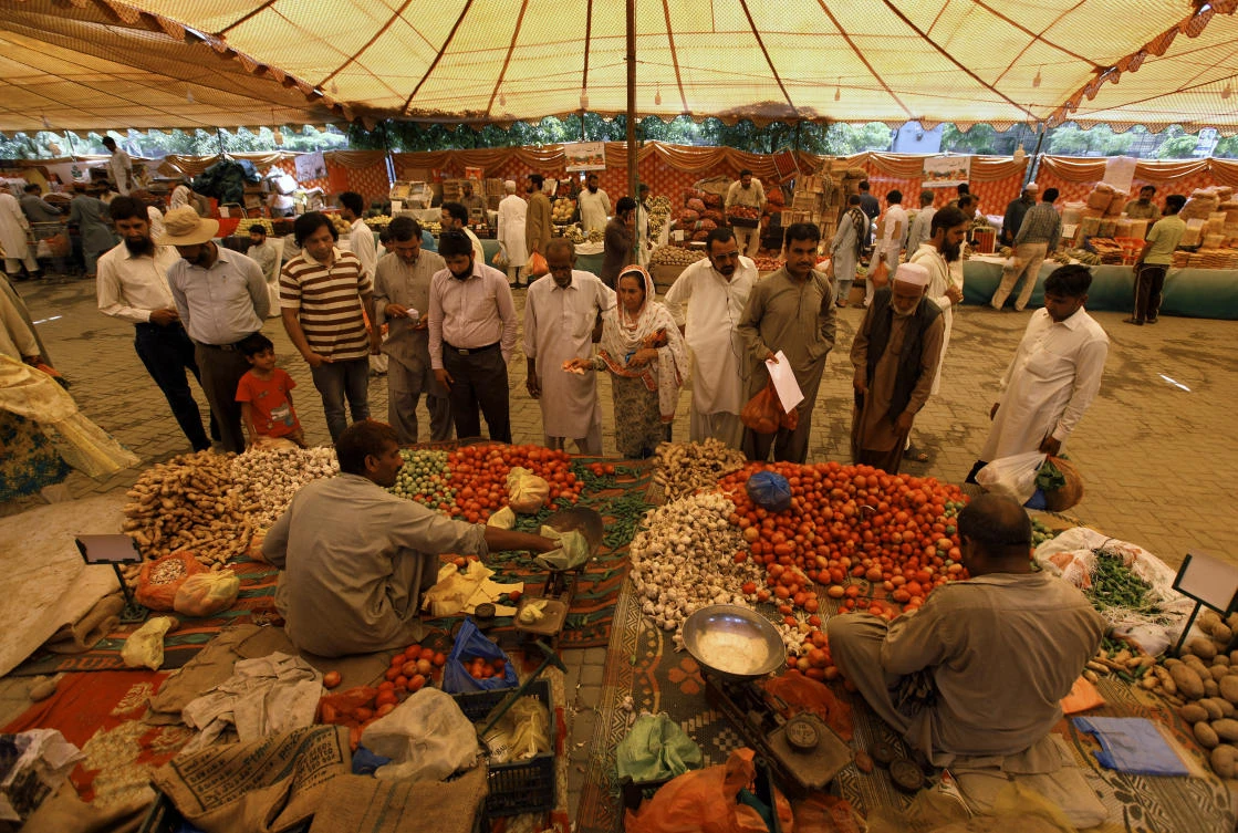 Pakistani Muslims buy vegetable and other items for 'iftar', the meal to break their fast, from a government-run bazaar specially set up for fasting month of Ramadan, in Rawalpindi, Pakistan, Tuesday, May 7, 2019. Muslims around the world are observing Ramadan, the holiest month in Islamic calendar. (AP Photo/Anjum Naveed)