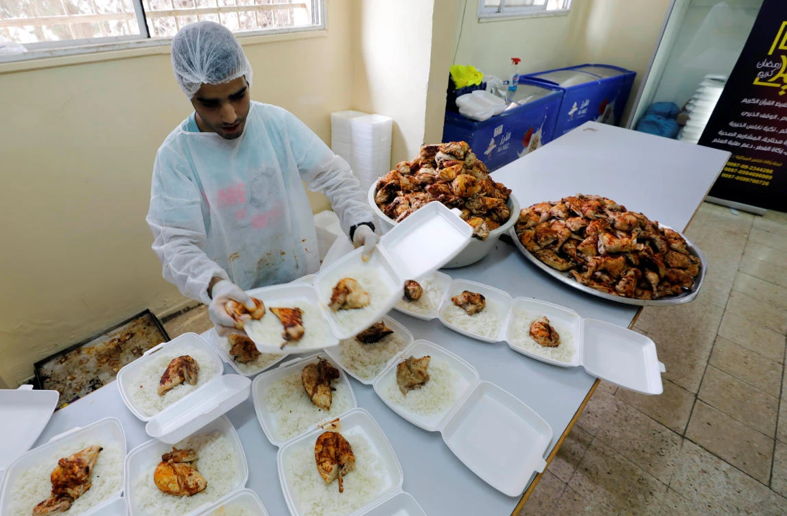 A Palestinian worker packs meals to be distributed by a charity as food donation for poor people during the Muslim fasting month of Ramadan, in Nablus in the Israeli-occupied West Bank, May 7, 2019. REUTERS/Abed Omar Qusini