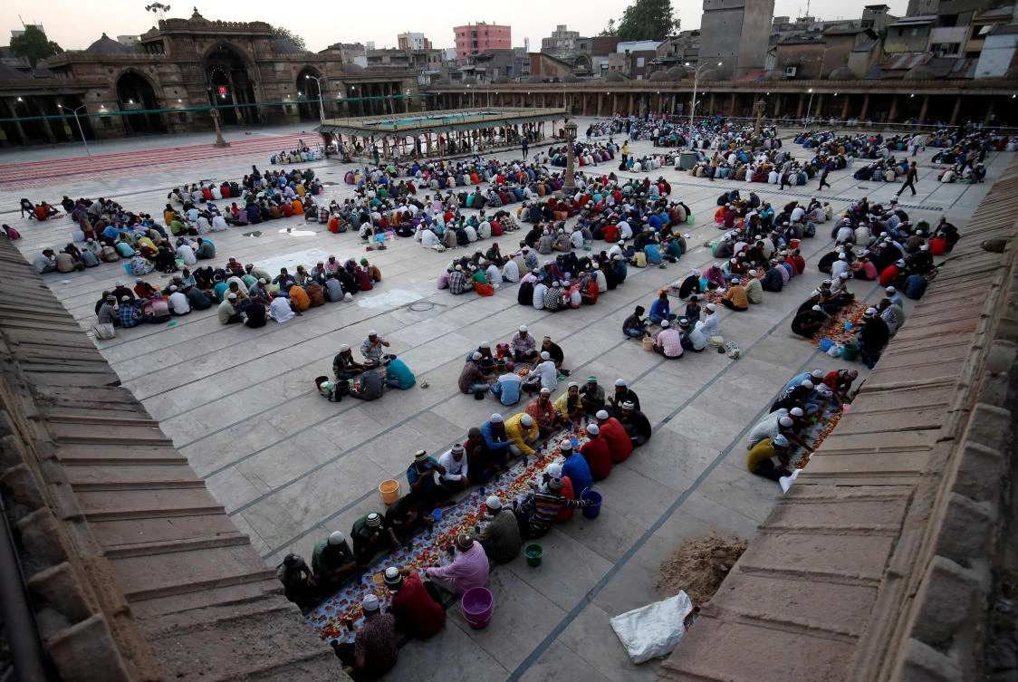 People eat their Iftar (breaking fast) meals on the first day of the Muslim fasting month of Ramadan at a mosque in Ahmedabad, India, May 7, 2019. REUTERS/Amit Dave