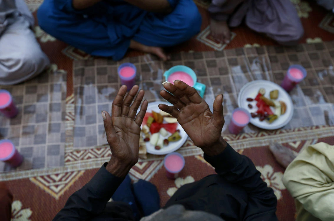 A Pakistani prays before breaking his fast during the Muslim fasting month of Ramadan, at a free food distribution point in Islamabad, Pakistan, Tuesday, May 7, 2019. Muslims around the world are observing Ramadan, the holiest month in Islamic calendar. (AP Photo/Anjum Naveed)
