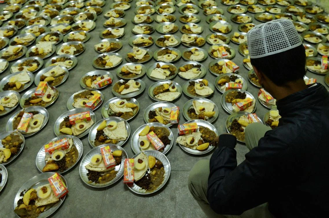 A Nepali Muslim man prepares food before breaking their fast at the Kashmiri Mosque on the first day of the Muslim holy month of Ramadan, in Kathmandu on May 7, 2019. Muslims throughout the world are marking the month of Ramadan, the holiest month in the Islamic calendar during which Muslims fast from dawn until dusk. / AFP / PRAKASH MATHEMA