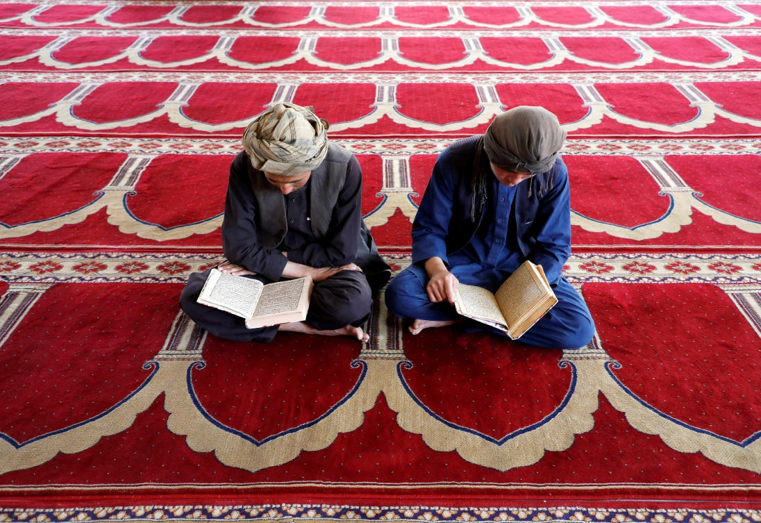 Afghan men read the Koran at a mosque during the holy month of Ramadan in Kabul, Afghanistan May 7, 2019. REUTERS/Omar Sobhani