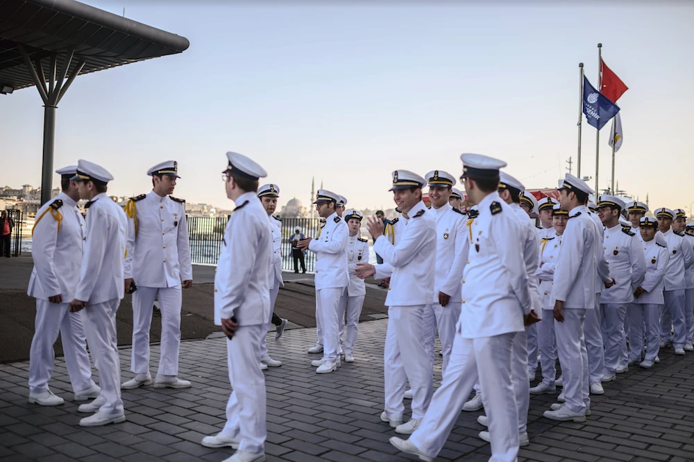 Students from the marine school wait to break their fast during the Islamic holy month of Ramadan at Karakoy dock, in Istanbul, on May 16, 2019.  (AFP)