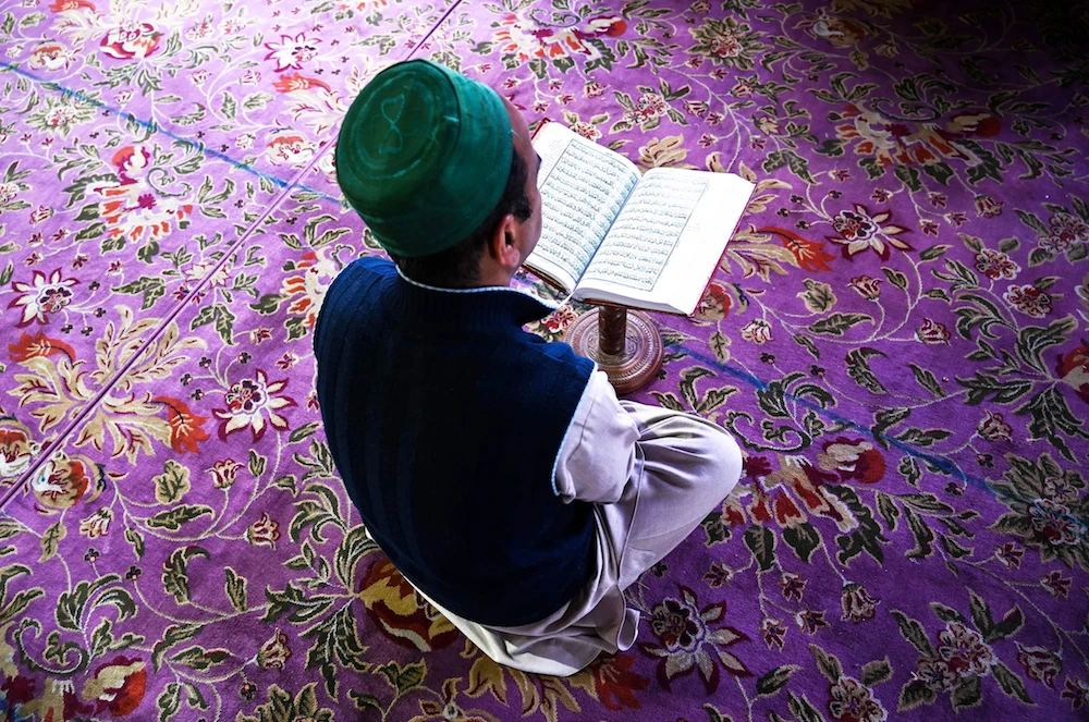 A Kashmiri Muslim reads the Quran at the Sheikh Abdul Qadir Geelani Shrine during the holy month of Ramadan in Srinagar on May 20, 2019. (AFP)