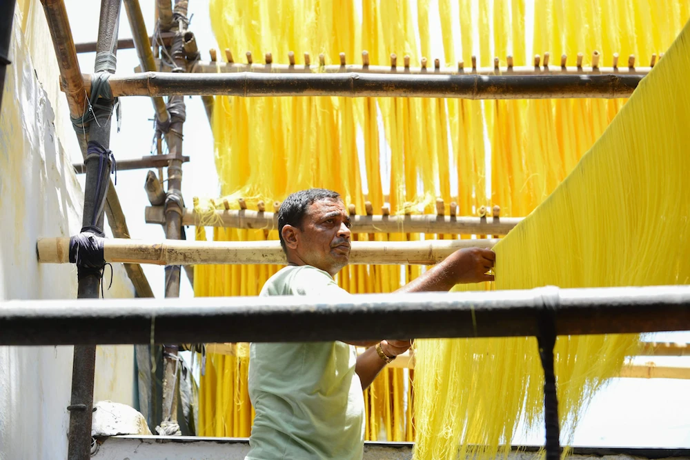 An Indian worker dries vermicelli made from saffron and milk at a workshop in Ahmedabad on May 20, 2019. Saffron Vermicelli are in high demand during the Holy Month of Ramadan and it's cost is three times higher than usually.  (AFP)