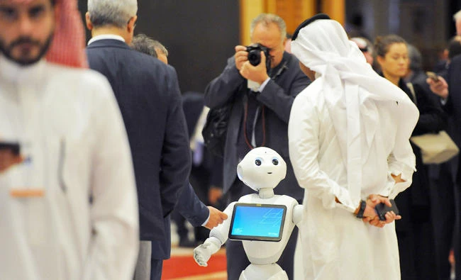 A Saudi man chats with a robot on the sidelines of the three-day Future Investment Initiatives conference in Riyadh, on October 25, 2017. (AFP)