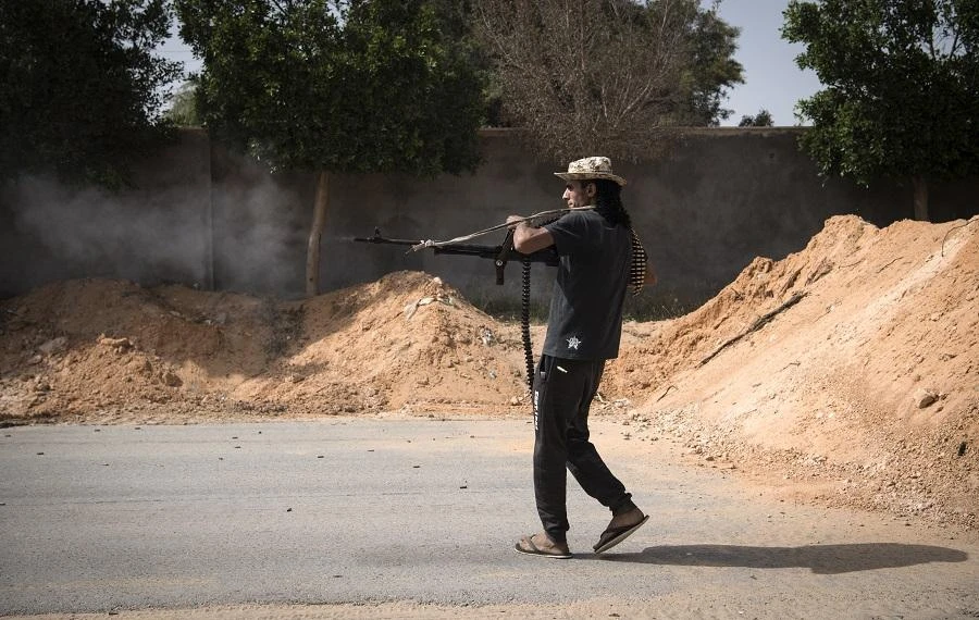 A fighter loyal to the internationally recognised Government of National Accord (GNA) fires his weapon during clashes with forces loyal to strongman Khalifa Haftar south of the capital Tripoli's suburb of Ain Zara, on April 25, 2019. (File/AFP)