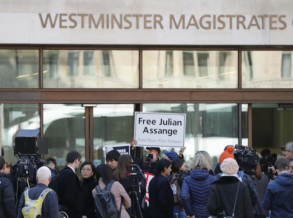 Media and supporters wait at the entrance of Westminster Magistrates Court in London, Thursday, May 2, 2019, where WikiLeaks founder Julian Assange is expected to appear by video link from prison. (AP)
