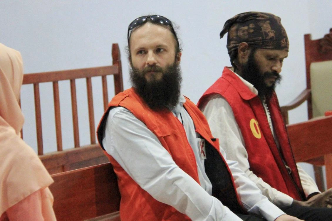 Polish national Jakub Skrzypski, center, listens to an interpreter as his Indonesian co-defendant Simon Magal looks on during sentencing. (AP Photo)